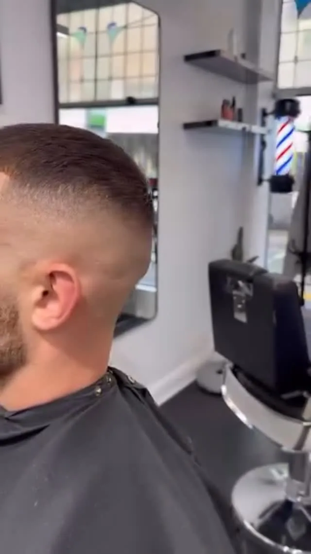 Fresh skin-fade cut, client caped in the chair